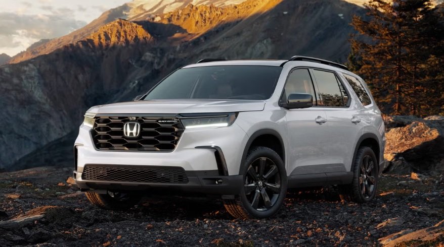 2025 Honda Pilot three-row SUV parked in a suburban driveway
